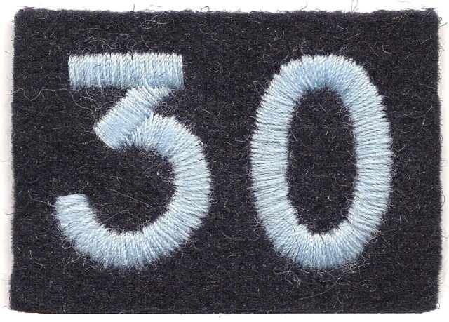 WW2 Shoulder Insignia of Fleming’s 30 Assault Unit. Worn in pairs, one each upper arm it consists of a Cambridge blue ’30’ on a dark navy blue backing. No other unit insignia was worn due to the high-security nature of the unit.