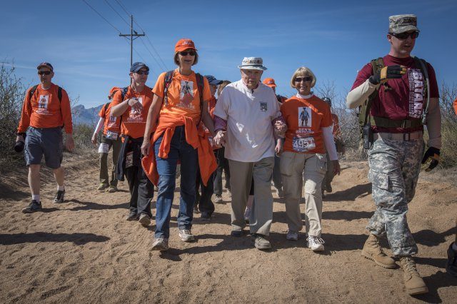 Bataan Death March survivor and retired U.S. Army Col. Ben Skardon walks in the Bataan Memorial Death March at White Sands Missile Range, March 20, 2016. Skardon is the only survivor of the real march who walks in the memorial march. He is joined every year by "Ben's Brigade", a group of former students and supporters who wear the orange of his alma mater, Clemson University, where he was also a professor. Credit: U.S. Army photo by Staff Sgt. Ken Scar.