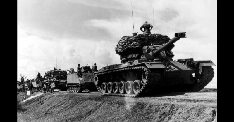 Vietnam: American Tanks and ACAVs secure supply route in 25th Infantry Divison area. Sandbags modify vehicles for security role as movable pillboxes.