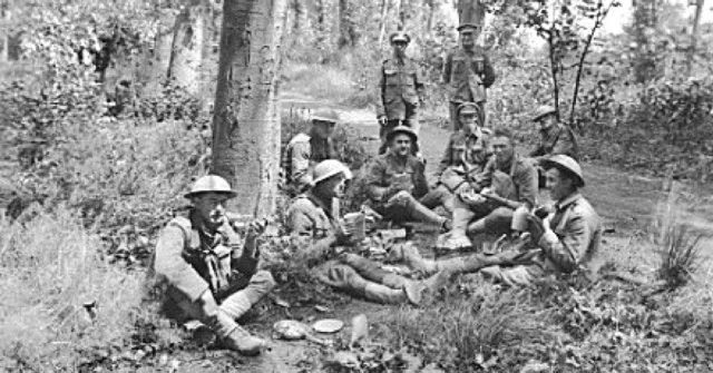 British, American and Australian troops taking lunch together in a wood near Corbie the day before the attack.