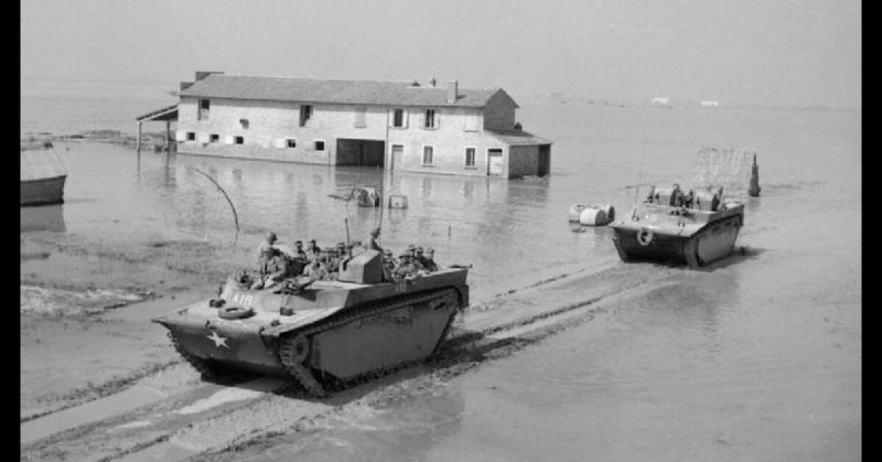 British forces move across the flooded landscape during the operation where Anders Lassen took his place in history. 