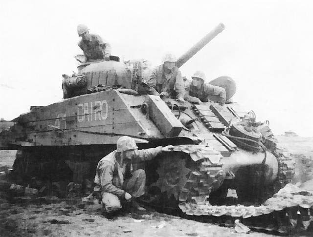 M4 Sherman ‘Cairo’ disabled by land mine, Iwo Jima, Japan, February 1945. Note heavy side planking meant to protect against demolition charges.