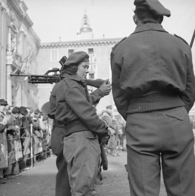 In the Piazza Garibaldi, Ravenna, Lieutenant General Sir R L McCreery (8th Army Commander) presented the Medaglio D’Oro to Major Buloff for distinguished services while commanding Partisan forces. This image shows a number of women who had been in action against the enemy, amongst the Partisans on parade at the ceremony.