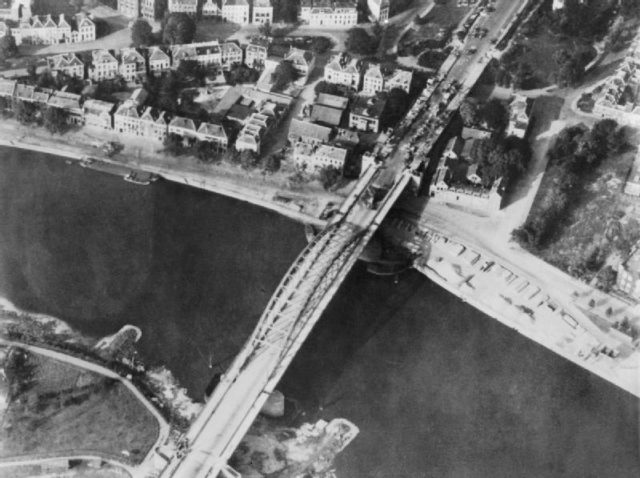 Aerial view of the bridge over the Neder Rijn, Arnhem; British troops and destroyed German armoured vehicles are visible at the north end of the bridge. September 1944.