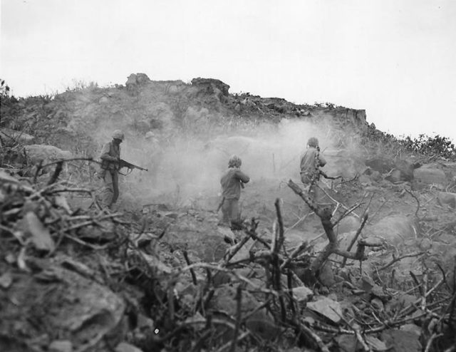 Four US Marines cleared out a cave with BAR, small arms, and grenades, Iwo Jima, February-March 1945.
