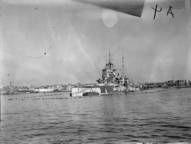 HMS Queen Elizabeth in Alexandria harbour surrounded by anti-torpedo nets.