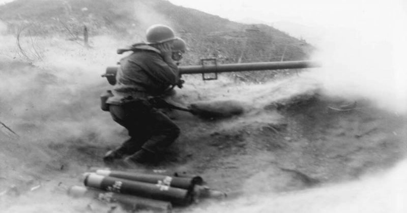 Recoilless rifle team fires their weapon at Chinese positition near Qnmong-Myon, Korea, 1951.