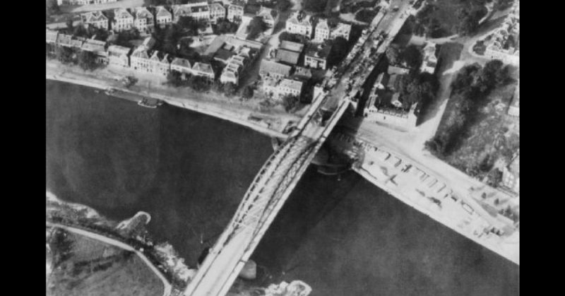 Aerial view of the bridge over the Neder Rijn, Arnhem; British troops and destroyed German armoured vehicles are visible at the north end of the bridge. September 1944. 