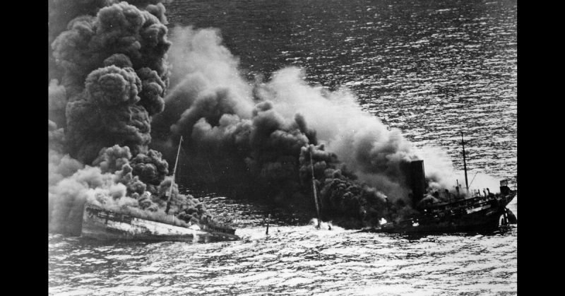 Allied tanker torpedoed in Atlantic Ocean by German submarine. Ship crumbling amidship under heat of fire, settles toward bottom of ocean, 1942.