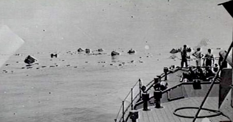 Survivors from the 's Jacob clinging to wreckage about to be rescued by HMAS Bendigo, 8 March 1943.