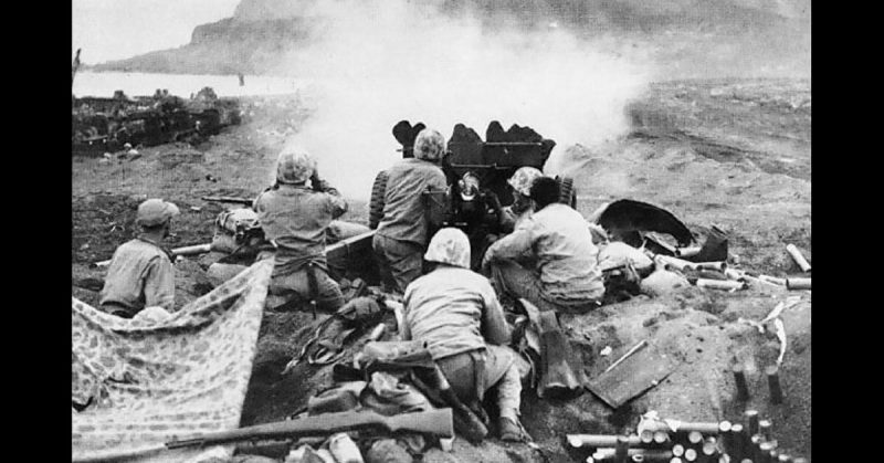 American 37mm (1.5 in) gun firing at Japanese cave positions on the north face of Mount Suribachi. 