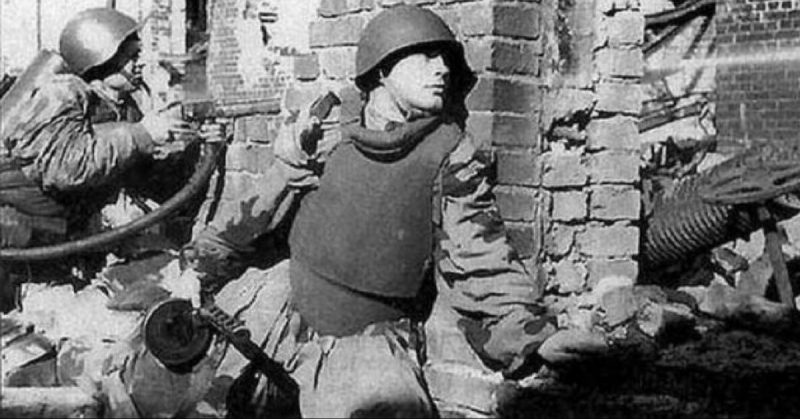 A Soviet soldier wearing a steel bib during combat.