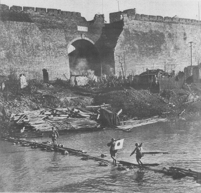 Japanese soldiers crossing the moat beside Nanking’s Zhonghua Gate