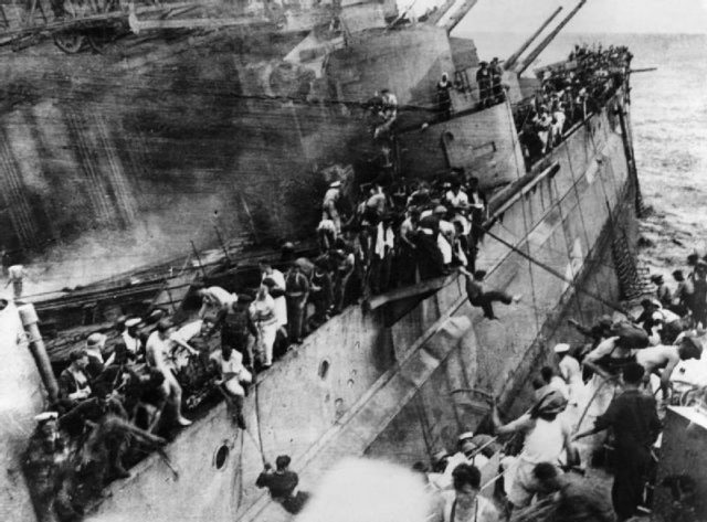 The Prince of Wales’s crew desperately tries to escape onto HMS Express before the ship is forced to pull away;