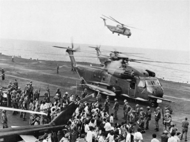 Evacuees from the DAO Compound are offloaded onto the U.S. Navy aircraft carrier USS Midway (CVA-41) during the evacuation of South Vietnam (“Operation Frequent Wind”), in April 1975.
