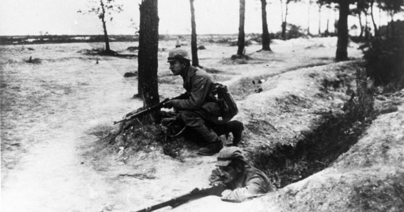 German guarding the entrance to a trench line during WWI. <a href=https://commons.wikimedia.org/w/index.php?curid=5368383>Photo Credit</a>