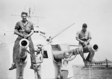 The crew of HMAS Sydney cleaning her forward turret;