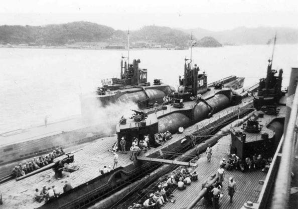 Photo above shows the huge 140 mm cannon on the aft deck plus the racks of 25mm AA-guns around the conning towers of the subs. It was an armament that was capable of confronting attacking aircraft as PBY Catalinas with their depth charges, bombs, and .50 Machine guns. If a scramble for a dive was too late, the shootout with overhead attacking aircraft was the only option left and the new AA guns were considered a powerful weapon to deter the enemy aircraft. Moreover, there were 8 x 5,5-inch torpedo tubes in the double hull under the bridge and hangar. This was a serious warship for long distances.