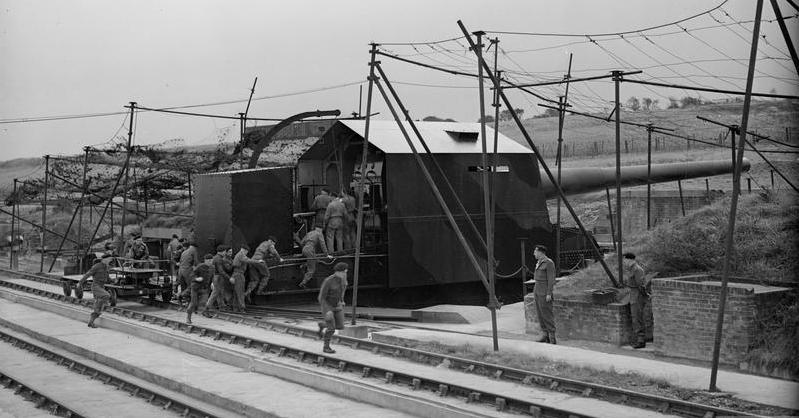 'Winnie and Pooh', British Cross-Channel Guns. The gun crew of 'Winnie' leaving the rail truck at the double to man their gun. Copyright: © IWM. <a href=http://www.iwm.org.uk/collections/item/object/205157444>Photo Credit</a> 