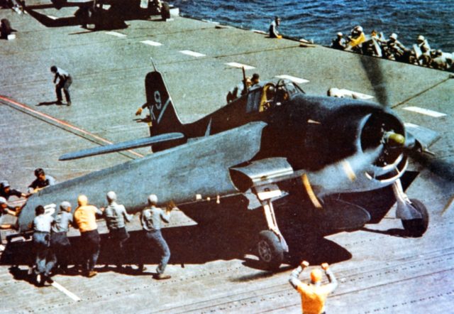 An F6F-3 aboard USS Yorktown has its Sto-Wing folding wings deployed for takeoff.