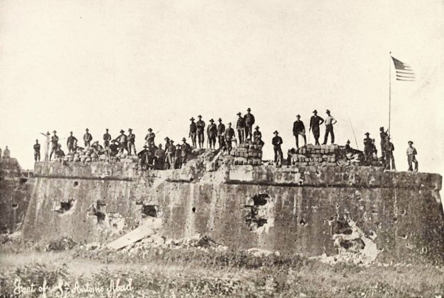 American troops raising the Flag at Fort San Antonio De Abad, Malate, Philippines, 1899.