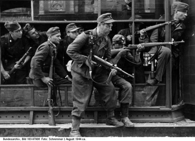 The Dirlewanger Brigade suppressing the Warsaw Uprising in 1944; By Bundesarchiv – CC BY-SA 3.0 de