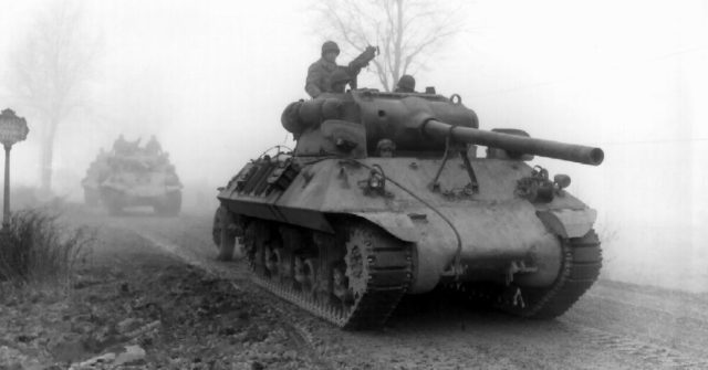 American armor moves forward through fog at the battle of the bulge.