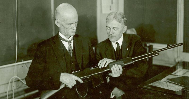 John M. Browning and Mr. Burton studying a BAR at the Winchester Repeating Arms Company plant, Connecticut, United States, circa 1918.