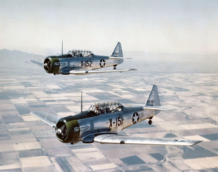 Two U.S. Army Air Forces North American AT-6C-NT Texan trainers (s/n 42-43925, 42-43929) in flight near Luke Field, Arizona (USA), in 1943.