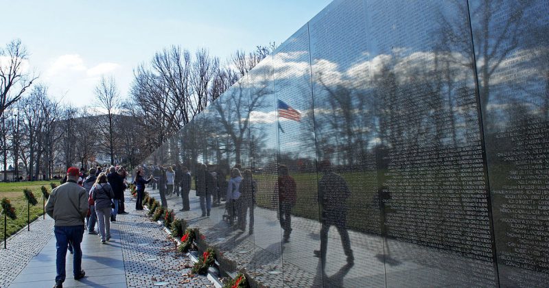 Vietnam Wall memorial.
 <a href=https://commons.wikimedia.org/wiki/File:US_flag_reflexion_on_Vietnam_Veterans_Memorial_12_2011_000124.JPG>Photo Credit</a>
