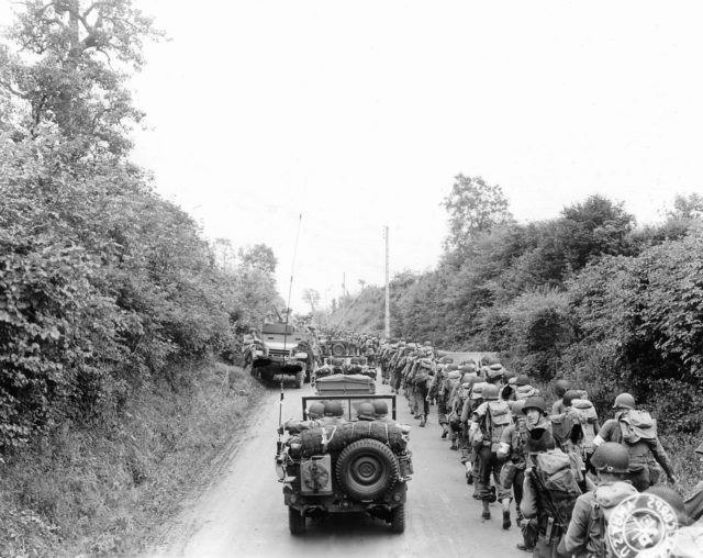 US Army soldiers and jeeps on their way to the front lines, Saint-Lô, France, July 1944.