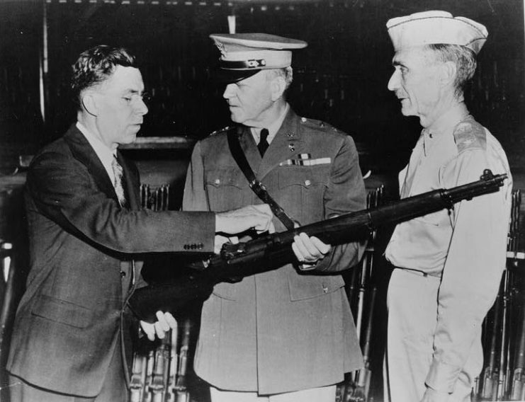 John Garand points out features of the M1 to army generals.
