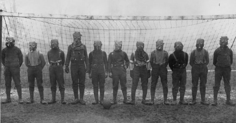 Football team of British soldiers with gas masks, Western front, 1916.