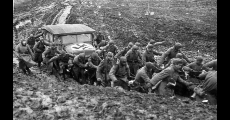 German soldiers drag equipment through the mud in Russia. 
