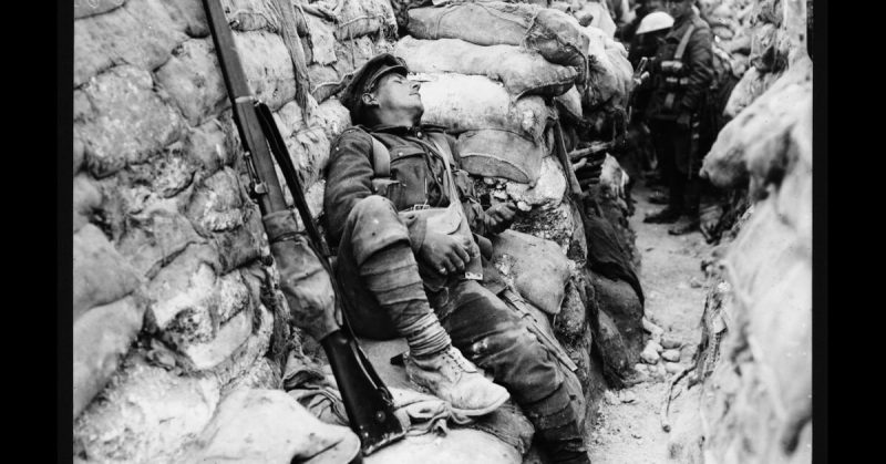 A soldier sleeps soundly in a trench near Thiepval, France, during World War I