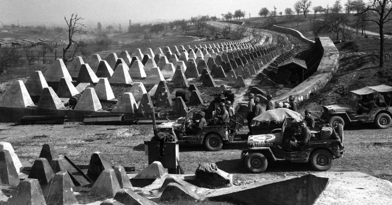 Soldiers of the US 7th Army pause at the Siegfried Line on the road to Karlsruhe, Germany, 27 March 1945.