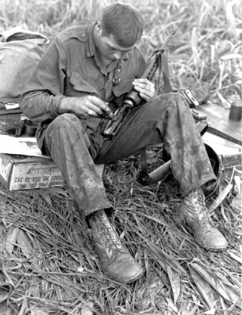 101st Airborne trooper cleans his XM16E1 during the Vietnam War in 1966.