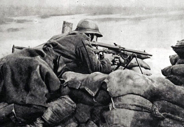 A Belgian machine gunner armed with a Chauchat, guarding a trench.