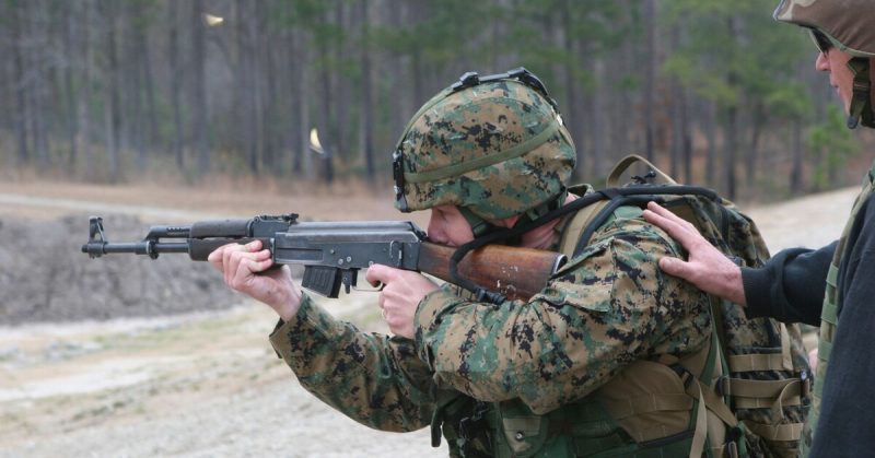 A Marine takes aim with an AK-47