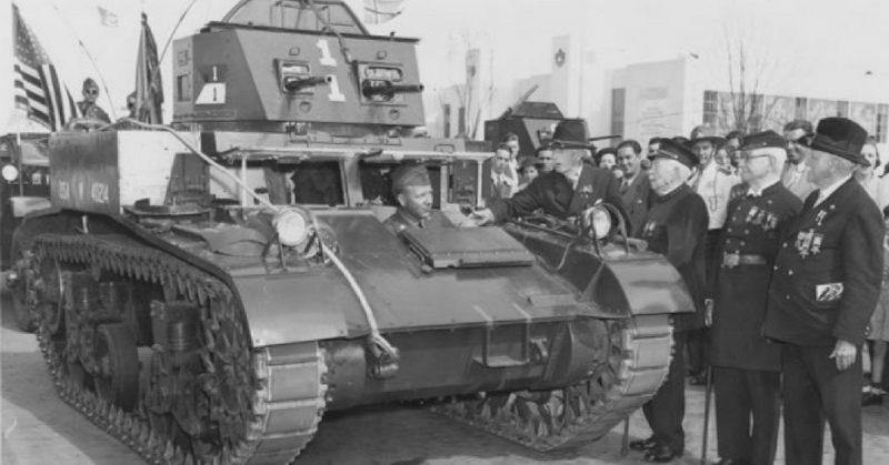 Civil War veterans (wearing Grand Army of the Republic uniforms) inspect an M1 Combat Car at the 1939 World's Fair in New York.