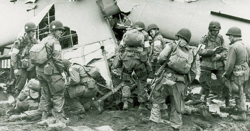 101st Airborne Division troops that landed behind German lines in Holland examine what is left of one of the gliders that 