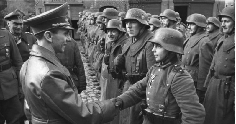 9 March 1945: Goebbels awards a 16-year-old Hitler Youth, Willi Hübner, the Iron Cross for the defence of Lauban. Photo: Bundesarchiv, Bild 183-J31305 / CC-BY-SA 3.0.