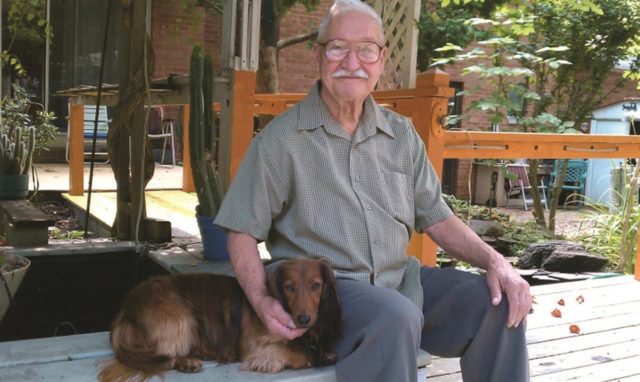 George on his back porch with Trixie the dog, 2015. (Author’s Collection)