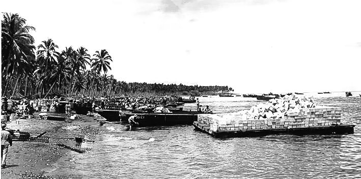 United States Coast Guard landing craft and barges delivering supplies to Guadalcanal, Solomon Islands, late 1942.