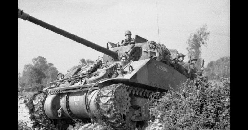 Sherman Firefly carrying infantry during Operation 'Goodwood', 18 July 1944.