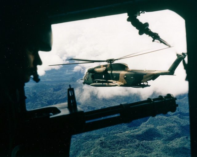 A Jolly Green Giant helicopter seen from another helicopter over Vietnam.