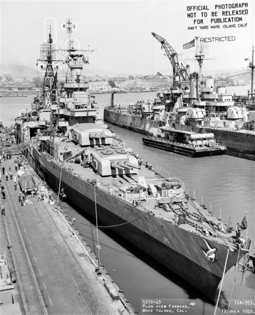 At the Mare Island Navy Yard after her final overhaul, 12 July 1945. Circles on photo mark recent alterations to the ship. Note stripped Cleveland class light cruiser in the right background, with YC-283 alongside. Photograph from the Bureau of Ships Collection in the U.S. National Archives.