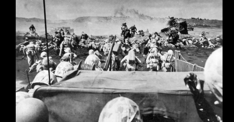 Marines storm ashore at the Battle of Iwo Jima.