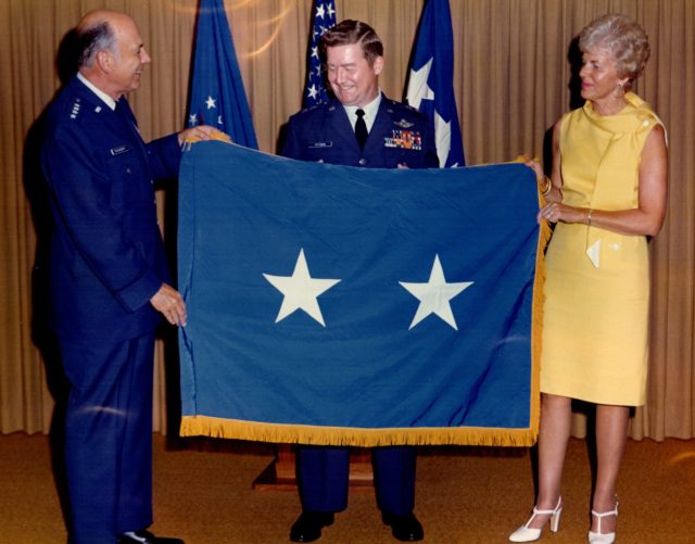 Don D. Pittman, center, is pictured in August 1975 receiving a flag denoting his promotion to major general in the Air Force. Pictured to his left is his wife, Arlene, who was his greatest supporter throughout his military career. Courtesy of Debbie Pash-Boldt.
