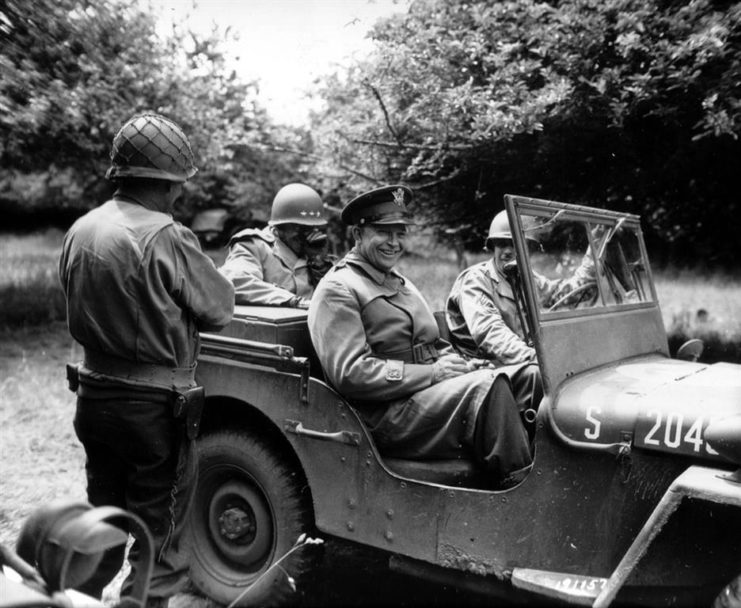 Eisenhower in jeep in Normandy orchard,1944.